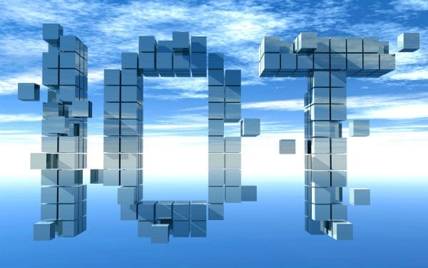 Blue sky with "IOT" or internet of things made of square blocks in the background