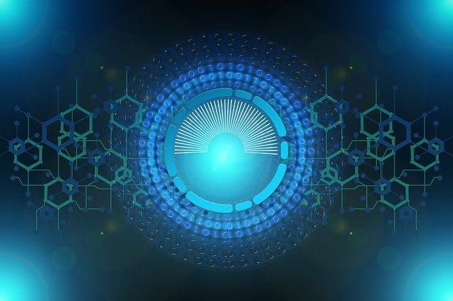 A glowing blue circular digital interface with radiating lines, geometric patterns, and hexagonal shapes, representing advanced technology or cybersecurity on a dark background.