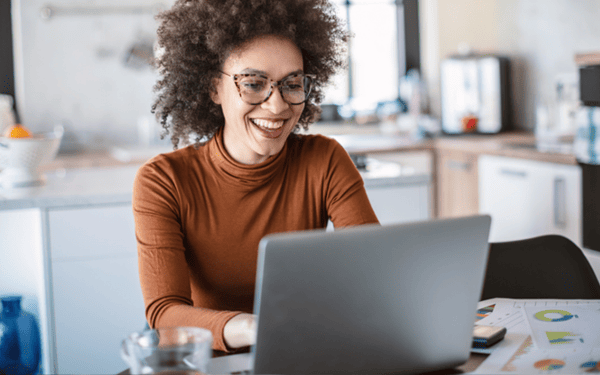 Woman wearing glasses working on her laptop