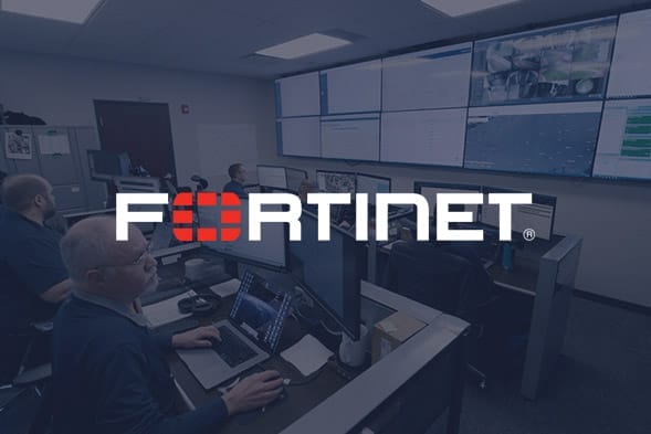 Several people work at computer desks in a control room with large wall-mounted screens displaying data; the Fortinet logo is prominently overlaid on the image.